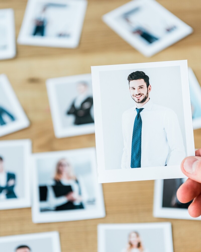 WhatzIndustry - cropped view of recruiter holding photo with man i 2024 11 19 12 55 04 utc uai